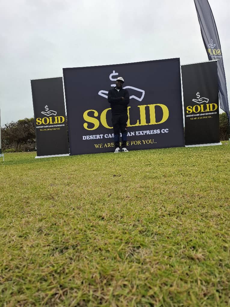Man standing with multiple SOLID banners