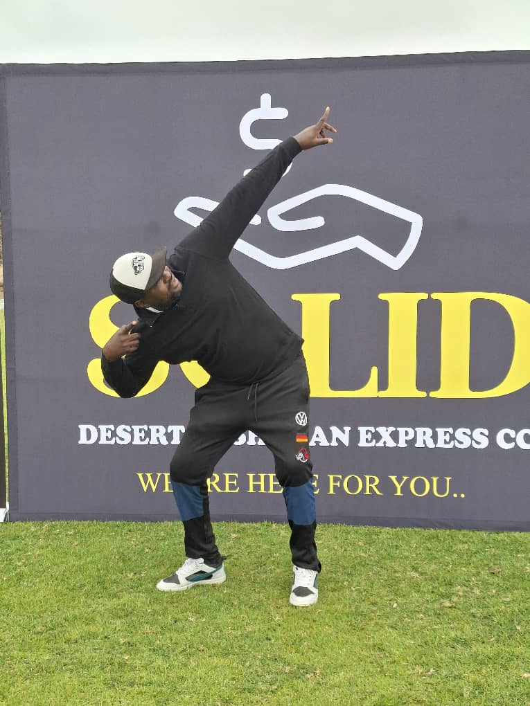 Man in black hoodie striking energetic pose