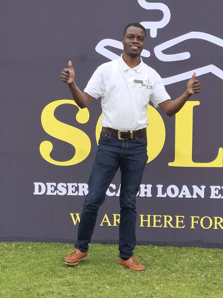 Man in white polo giving double thumbs up