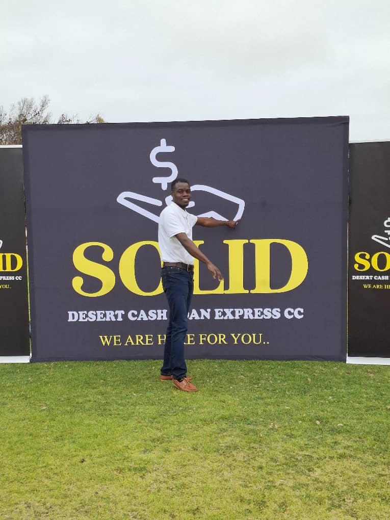 Smiling man with SOLID banner