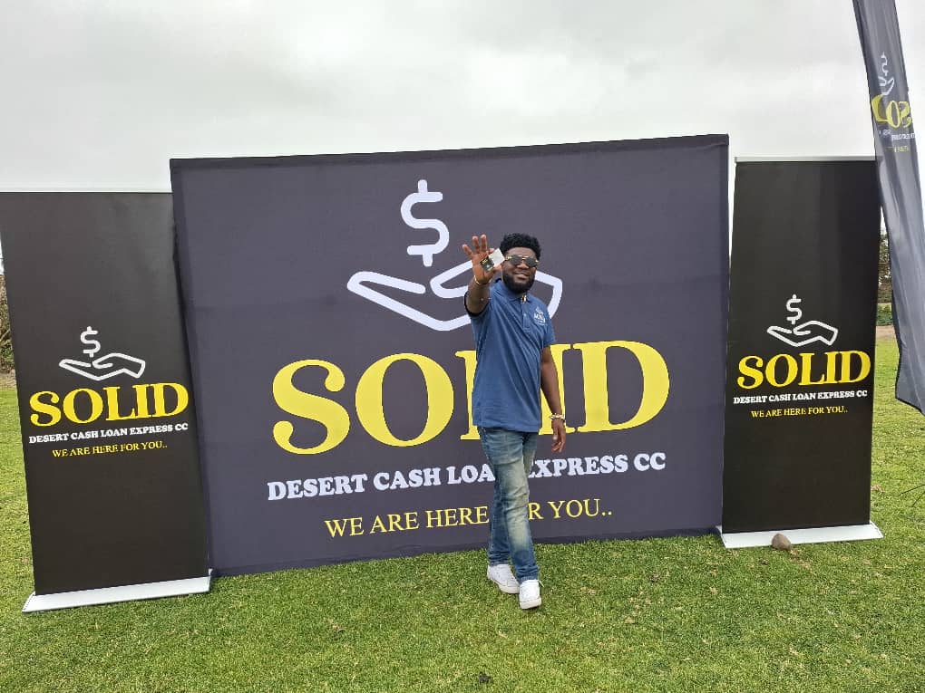 Team member extending hand with promotional banners