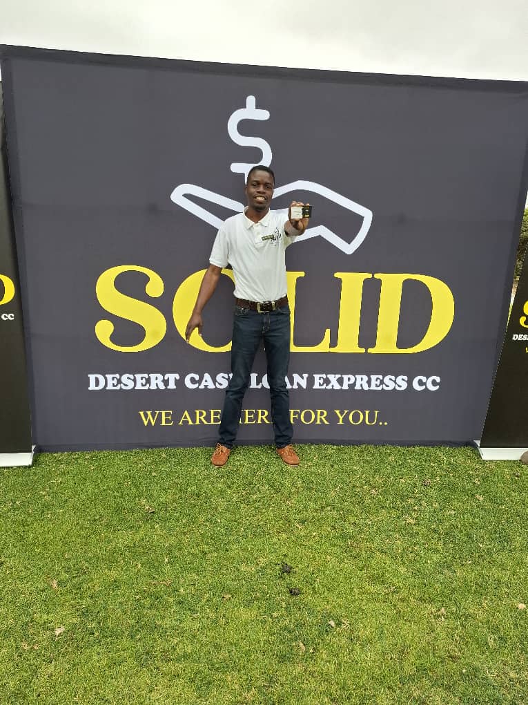 Smiling team member with SOLID banner