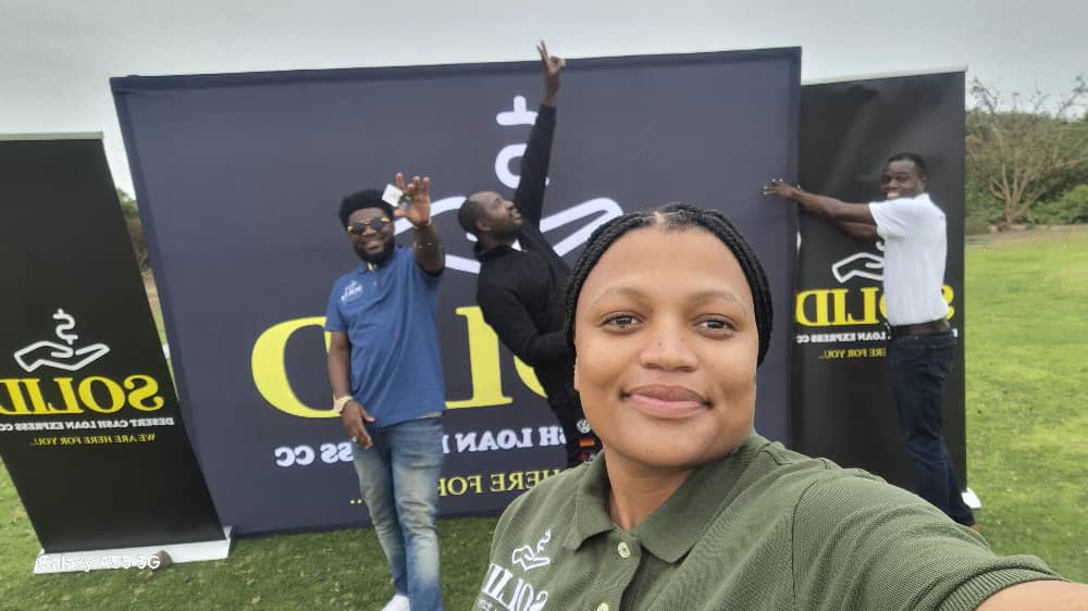 Woman in green shirt with team behind