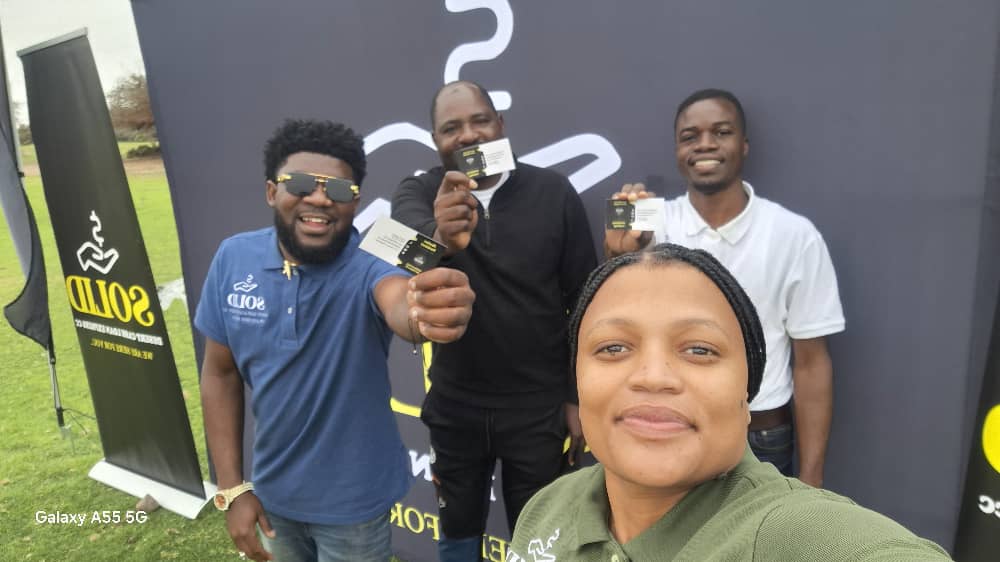 Four team members posing enthusiastically